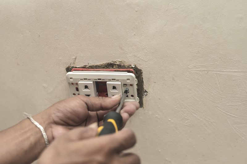 Electrician Repairing Outlet